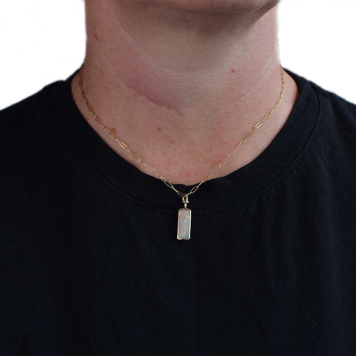 Reverse side of ONG002 Dual Horizon necklace showing double-sided opal's purple and green colour play in 14K gold setting