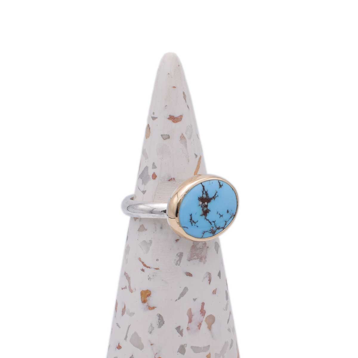 Ring with turquoise stone on a decorative cone
