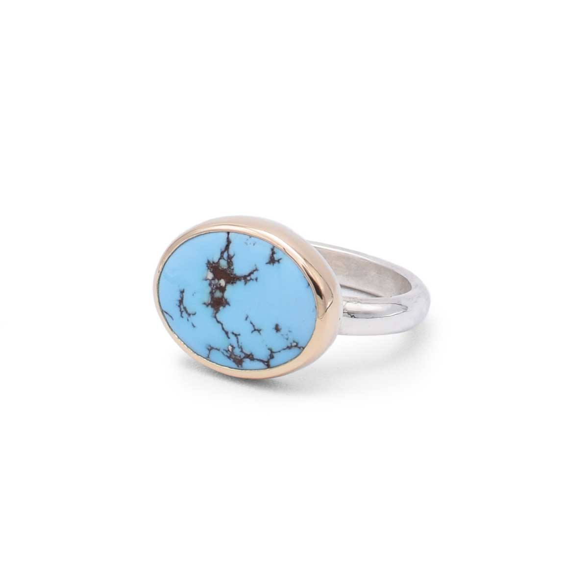Ring with a blue stone and silver band on a white background