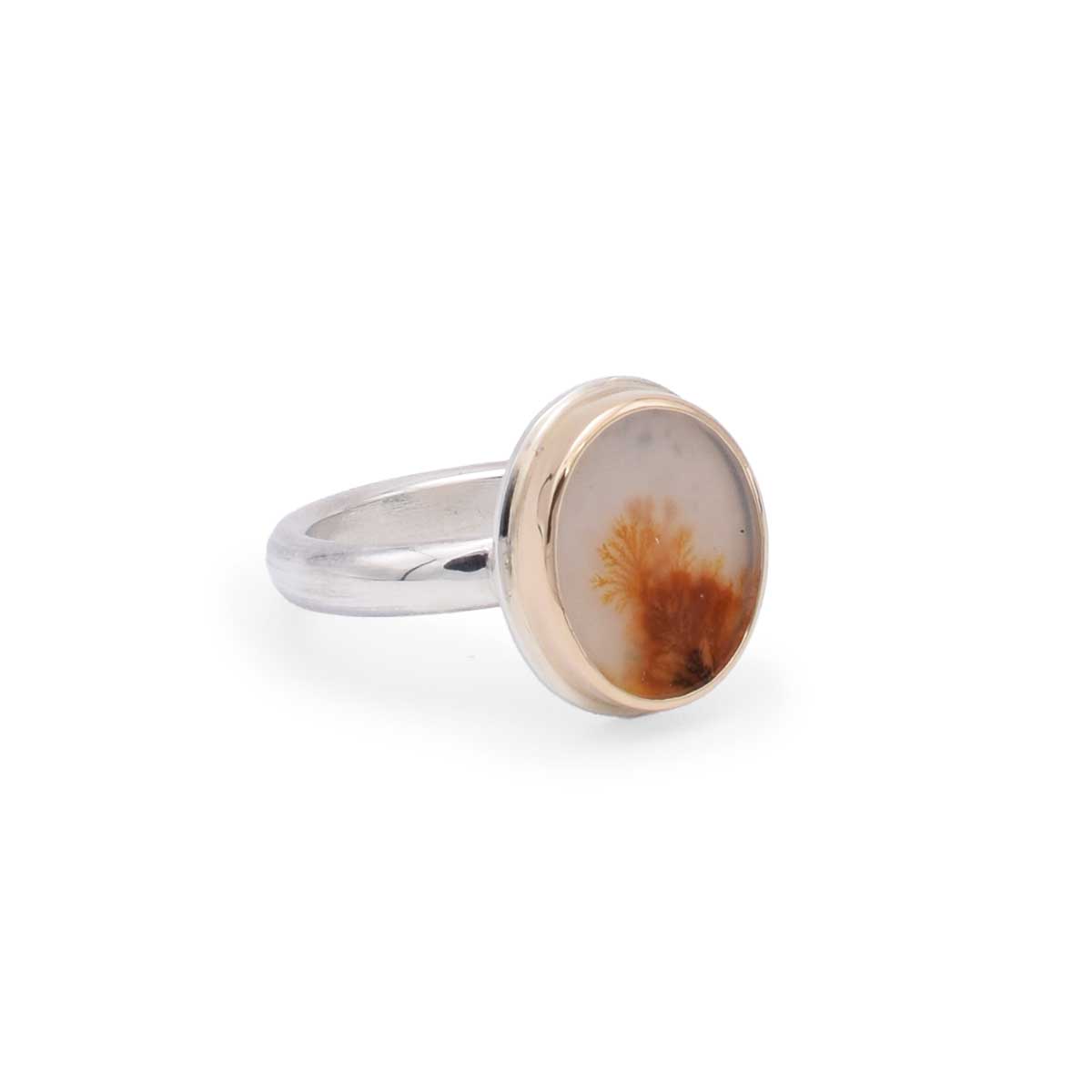 Ring with a brownstone-like stone on a white background