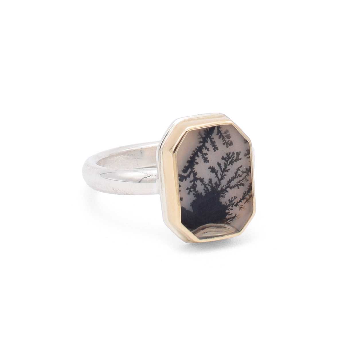 Ring with a dendritic agate stone on a white background
