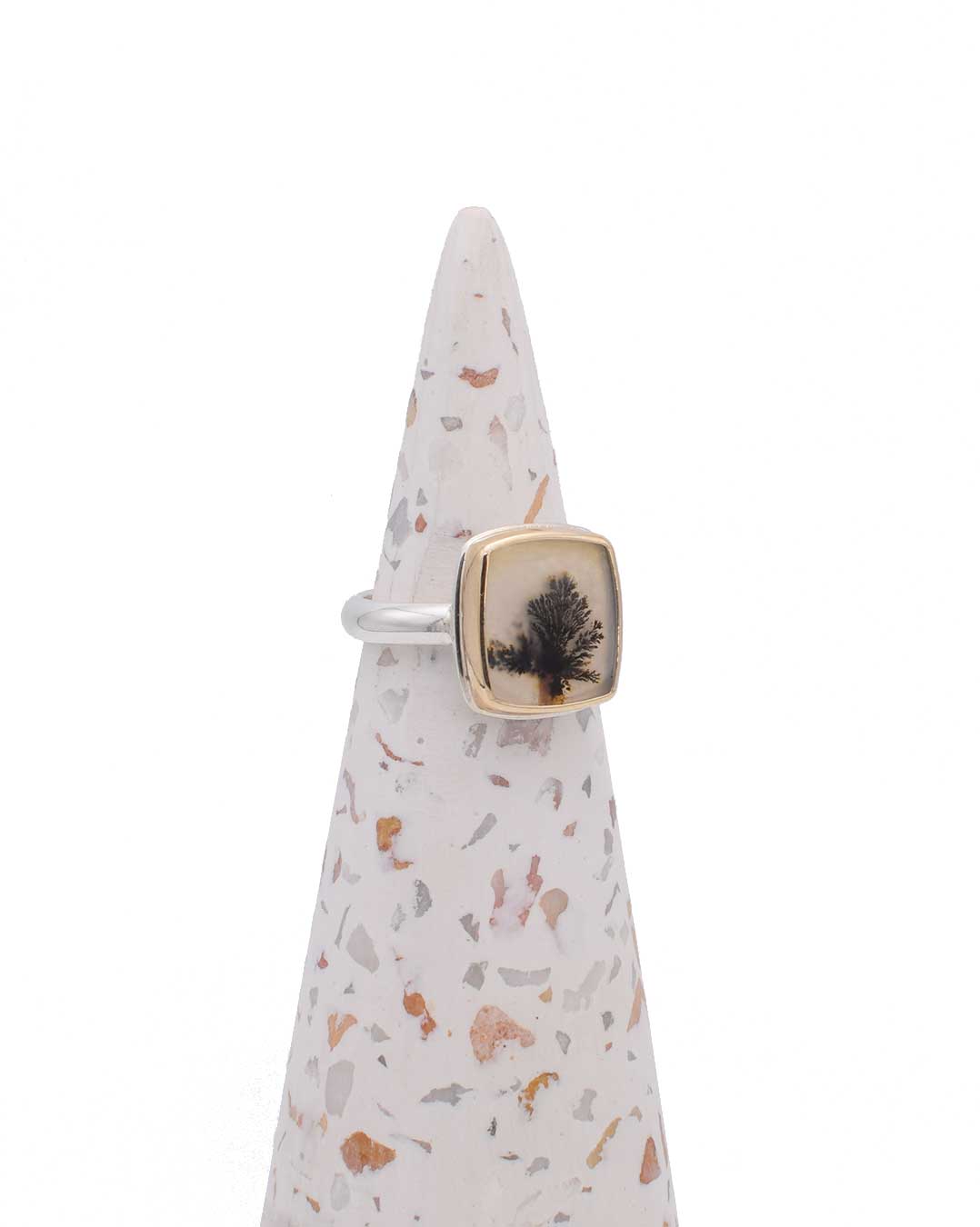 Side view of OOAKR185 Solitary Tree ring showing dendritic agate's square shape with soft rounded edges in 14K gold setting with sterling silver band