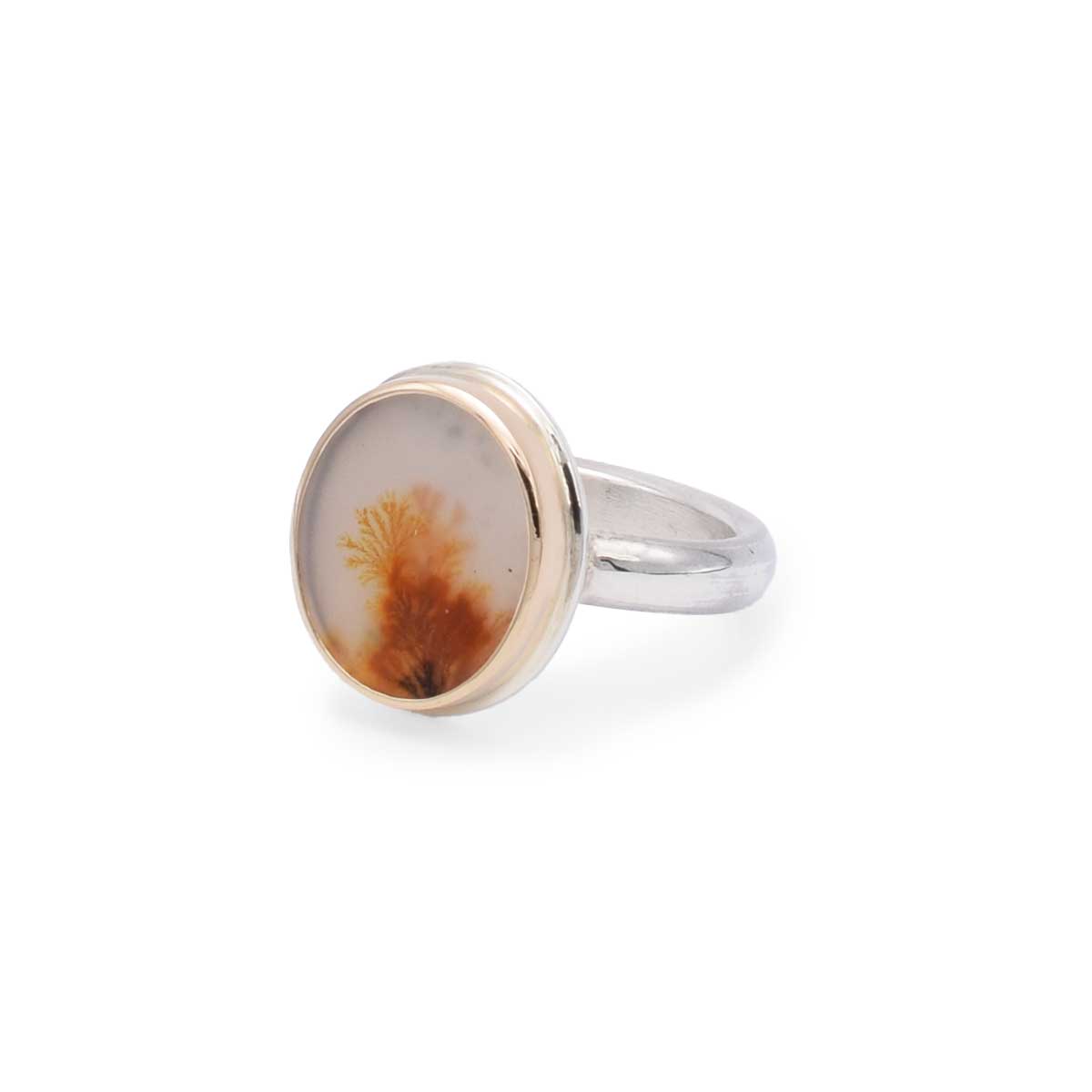 Silver ring with a circular stone featuring natural brown and beige patterns on a white background