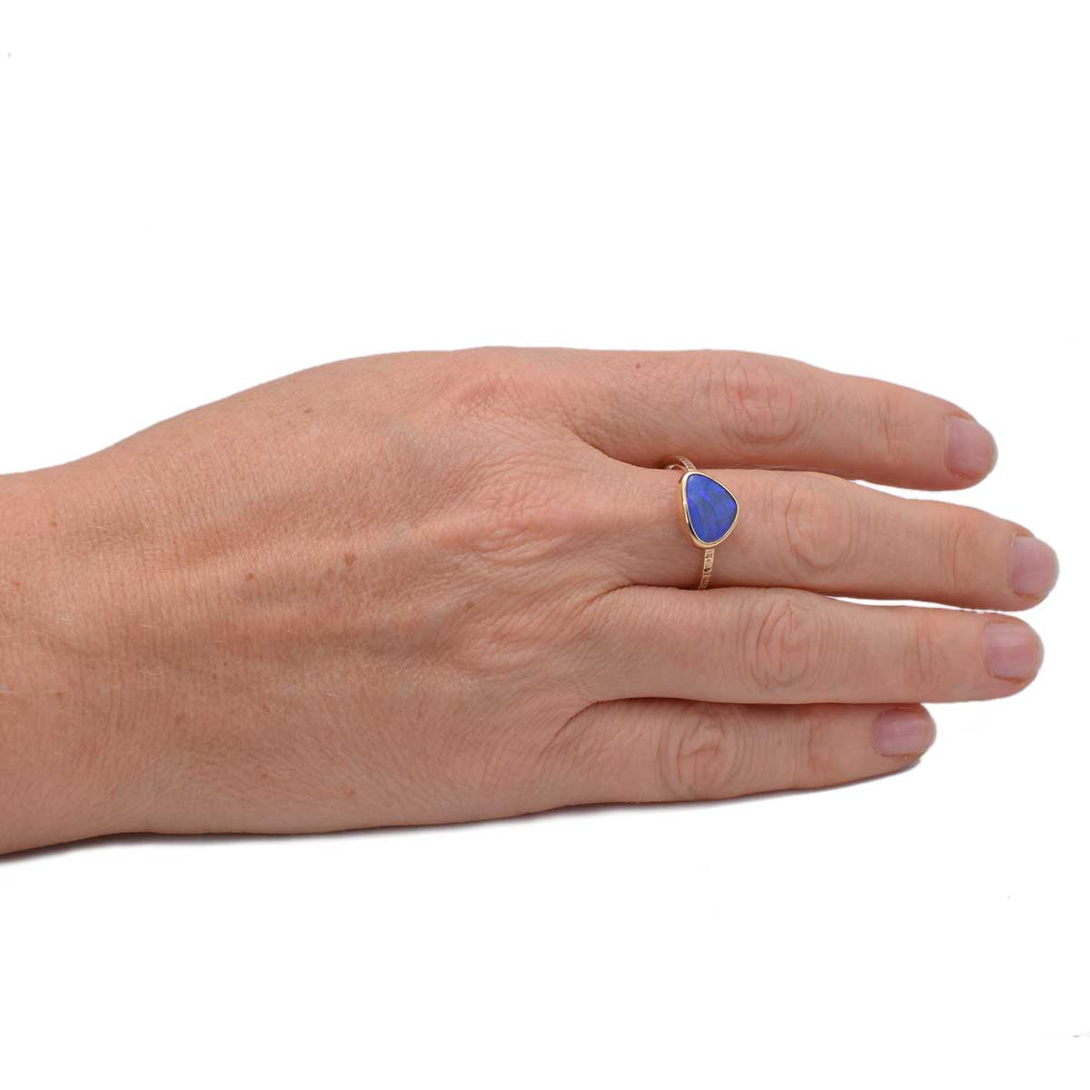 Lightning Ridge opal ring showing intense purple flashes against textured gold band