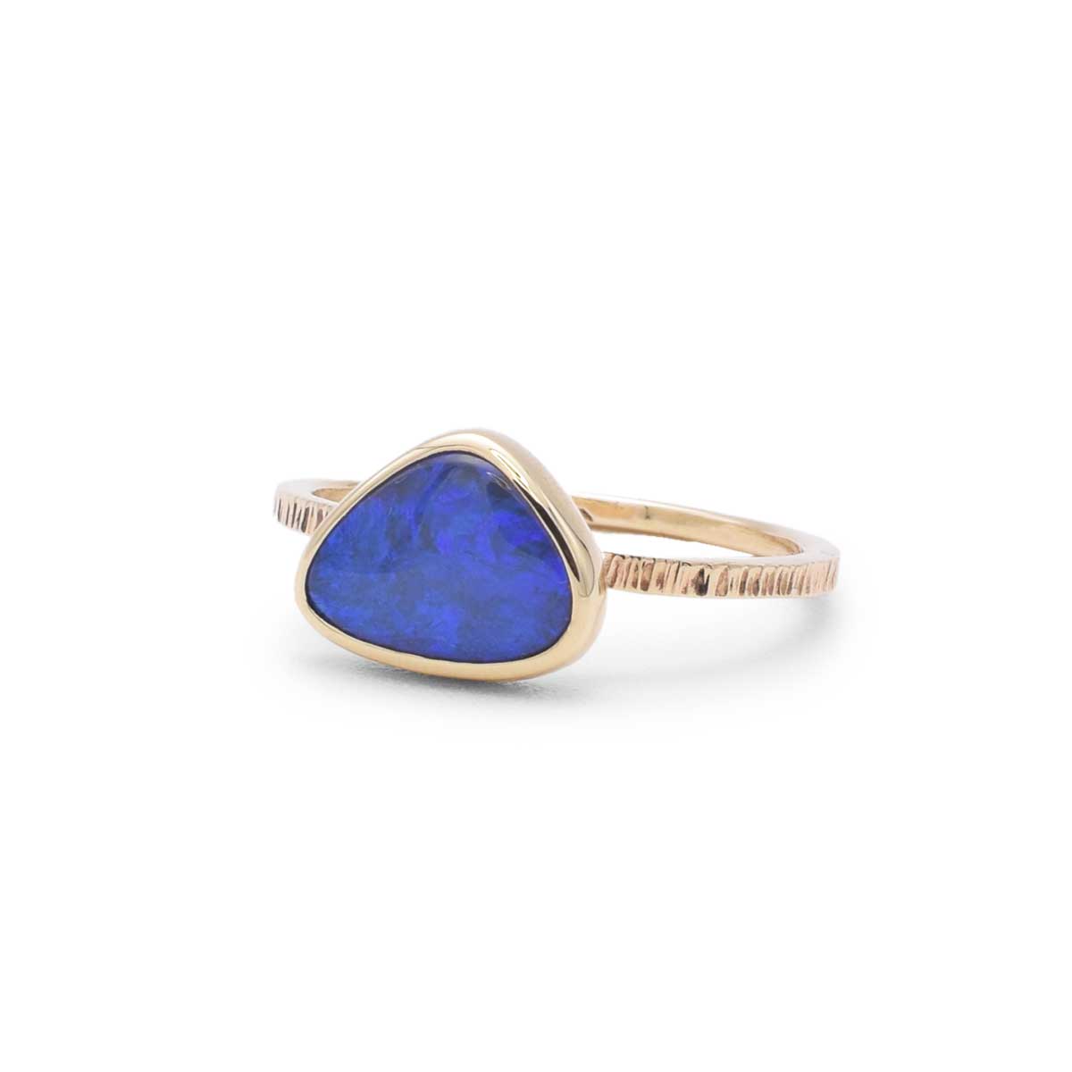 Semi black opal ring with purple and blue colour play in 9K yellow gold bezel setting