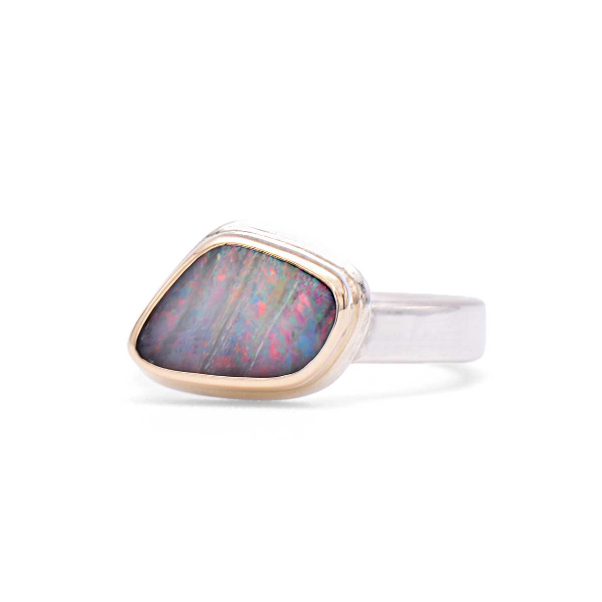 Prism Angles handcrafted ring featuring triangular boulder opal with rainbow striations in 14K gold bezel and sterling silver band - ORMM116