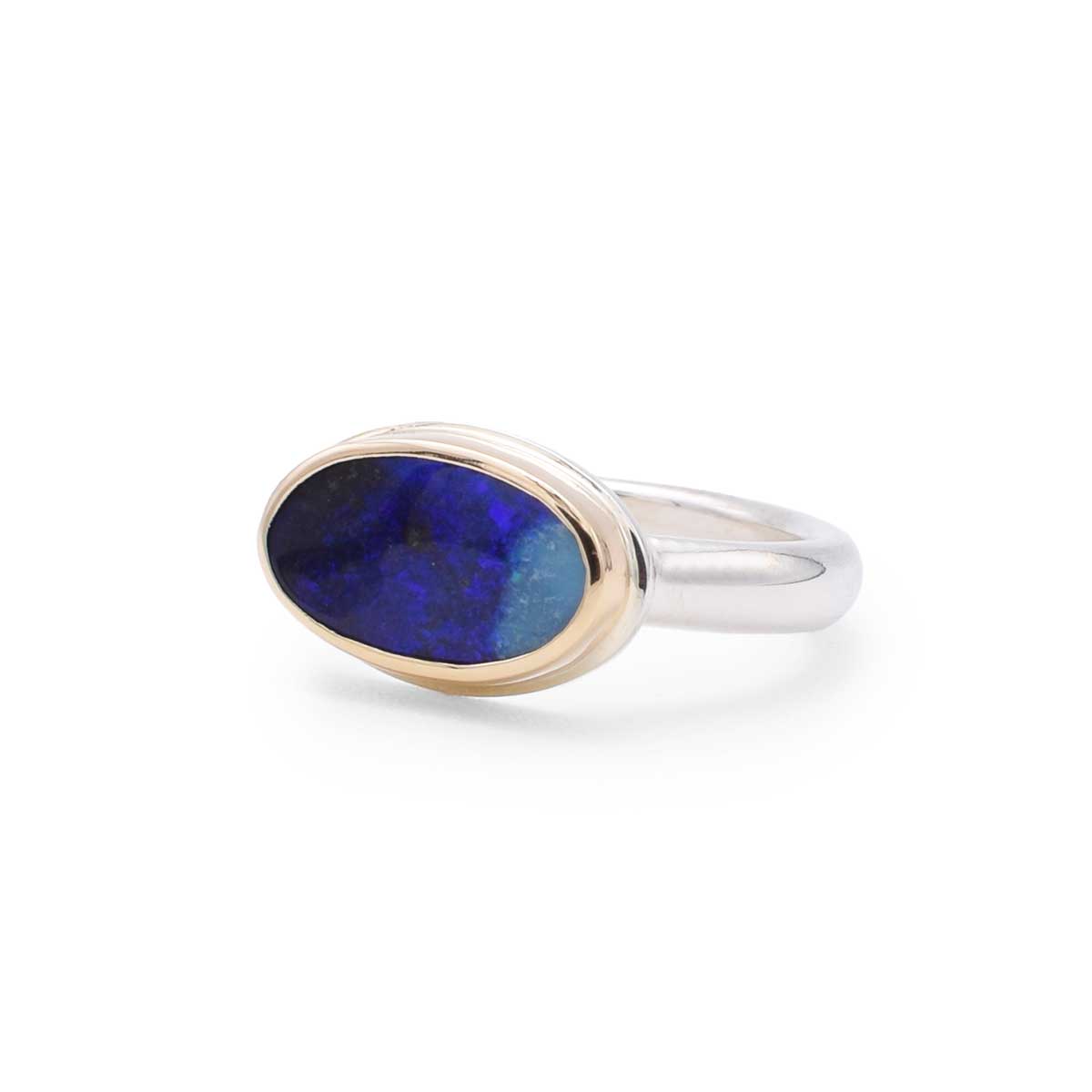 Ring with a blue stone and gold accent on a white background